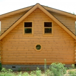 A frame False Shed Dormer Log Home