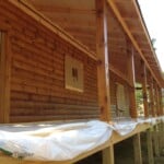 Staining Rear of Log Cabin