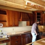 kitchen cabinets and wooden hood range in log home