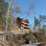 log home on hill overlooking view