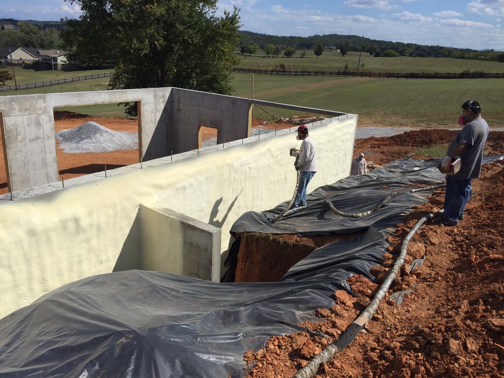 foam water protection being installed on concrete walls