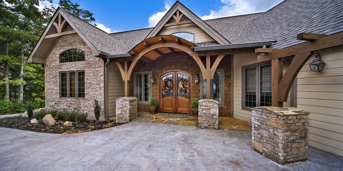The Southern Comfort by Custom Timber Log Homes - Craftsman style home with arched entry and a Mountain View