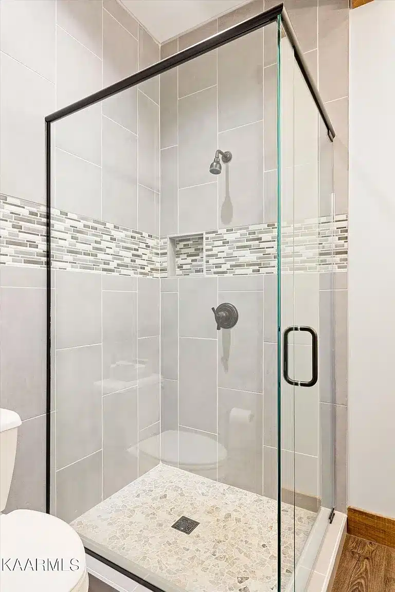 All Glass Shower with Tile surrounds and stone tile flooring